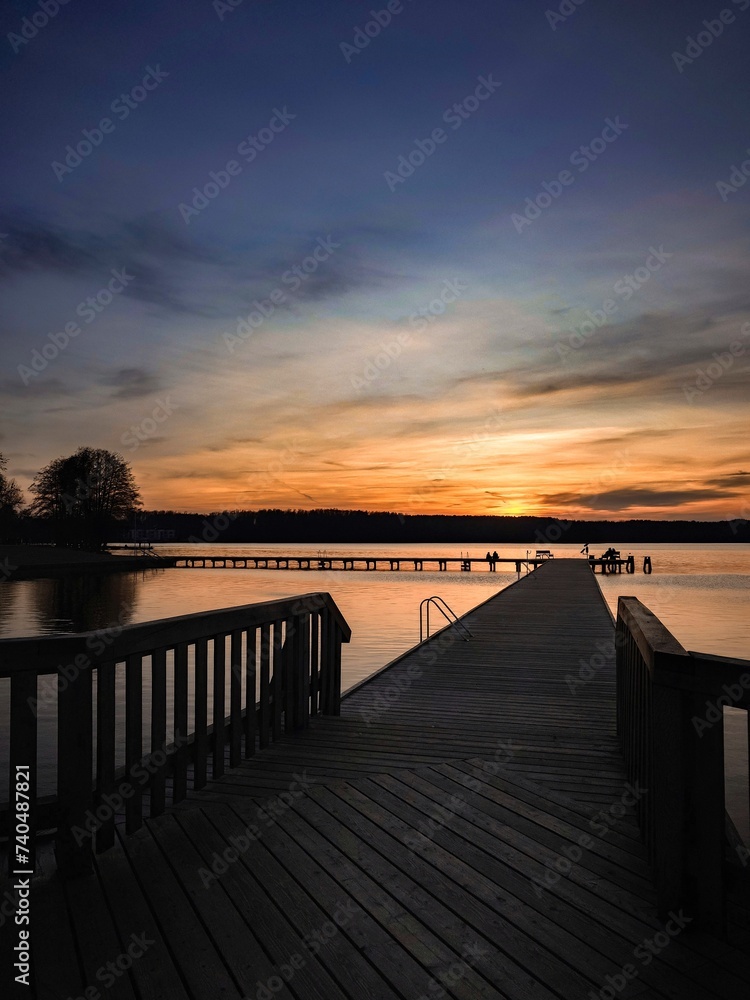 Sunset on the pier. Olsztyn. Lake Ukiel
