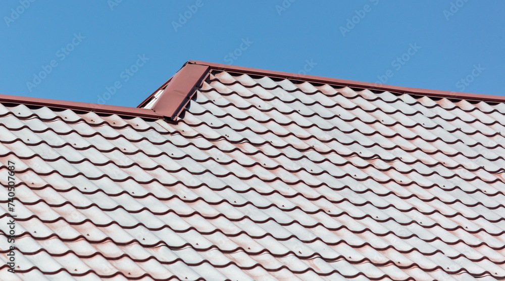 Naklejka premium Metal tiles on the roof as an abstract background. Texture
