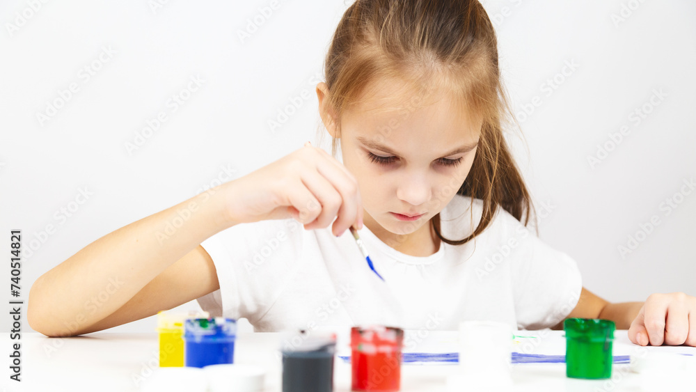 Child girl painting draws are engaged in creativity in school Child girl painting draws are engaged in creativity in school