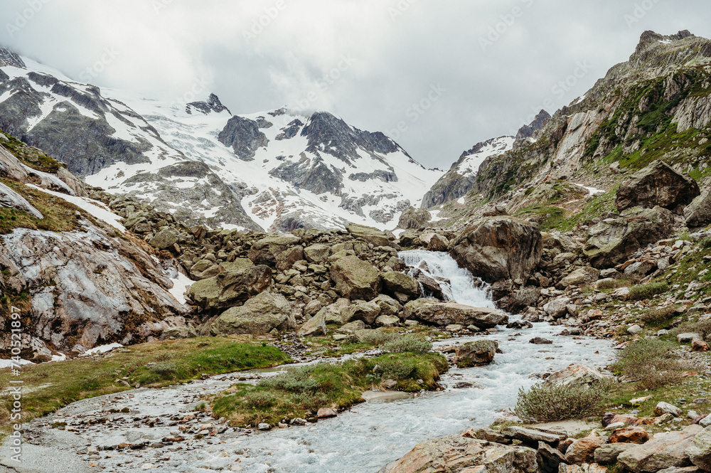 Waterfall with river at Sustenpass in the swiss mountains