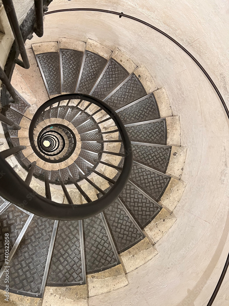 Fototapeta premium Never ending winding staircase with black railing