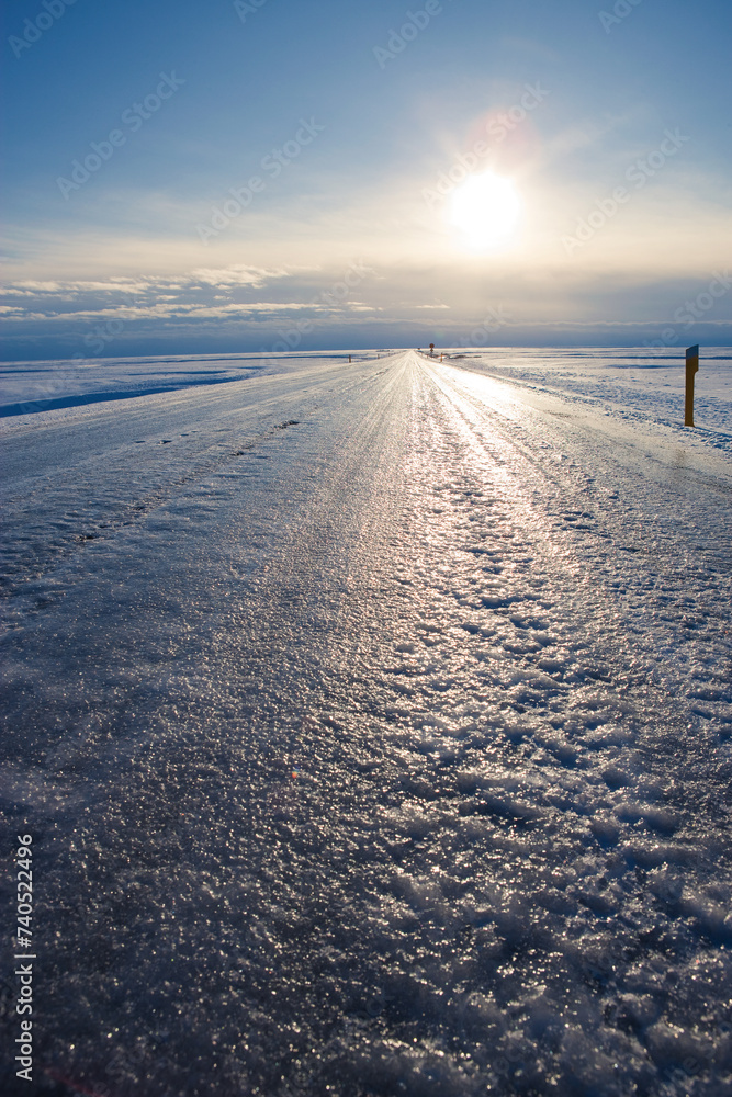 Dangerously Icy road and winter sun Dangerously Icy road and winter sun