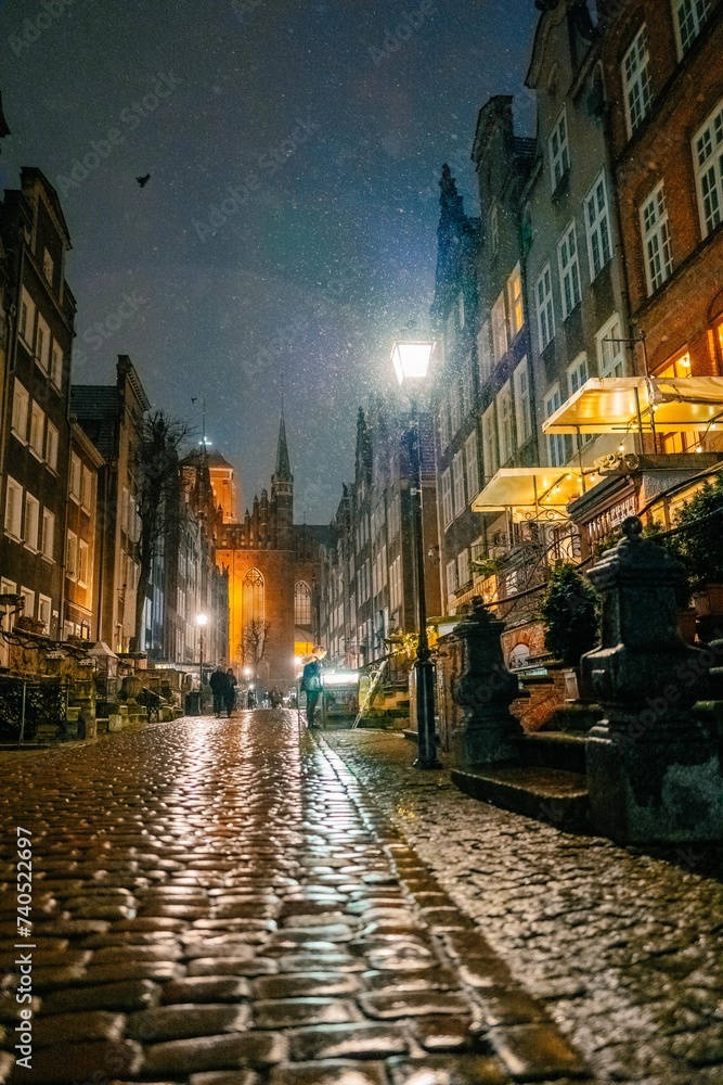 Fototapeta premium evening street in the old town in Gdansk Poland, snowstorm