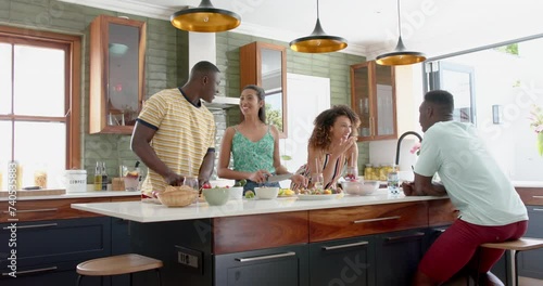 Diverse group enjoys a conversation in a modern home kitchen
