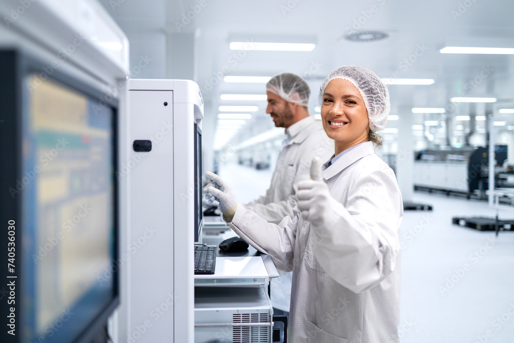 Portrait of female production line worker working in modern factory. Portrait of female production line worker working in modern factory.