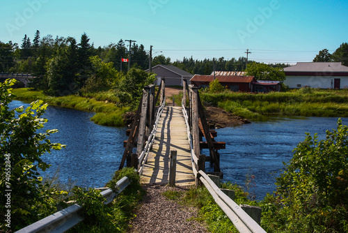 Scenic view of a blue river with lush vegetation and houses in Port Elgin, New Brunswick photo