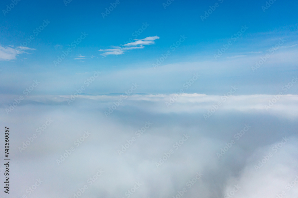 Aerial view of the city in the fog. Skyscrapers above the fog Aerial view of the city in the fog. Skyscrapers above the fog