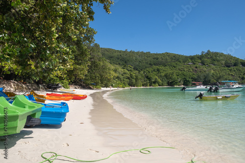 colorful boats on the tropical white sand beach Port Launay beach Seychelles © moeimyazanyato