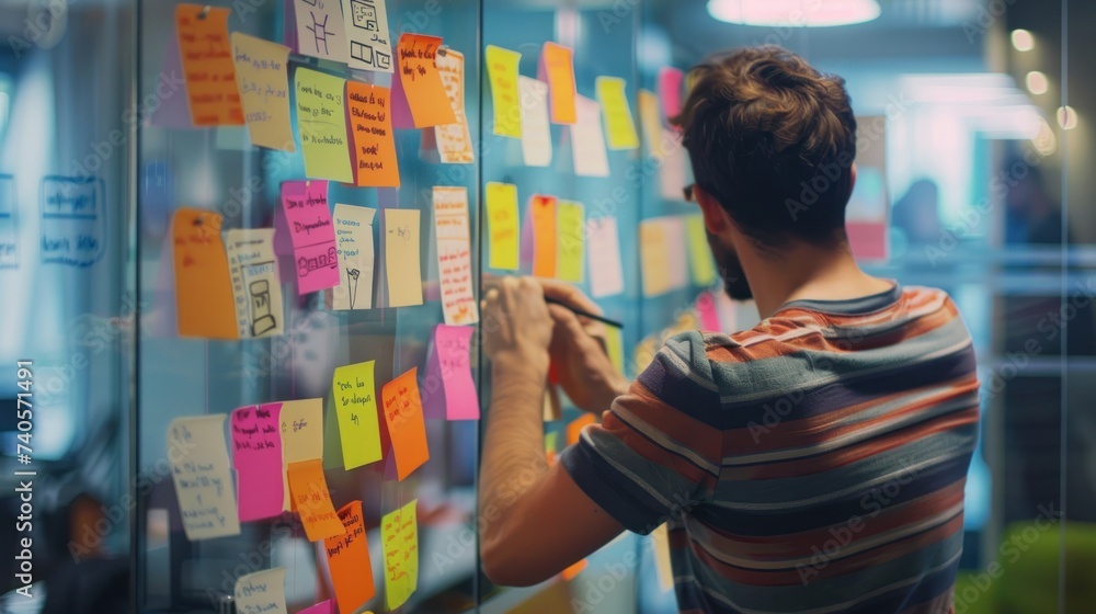Businessman planning and strategy brainstorming working with post its on glass wall. Businessman planning and strategy brainstorming working with post its on glass wall.
