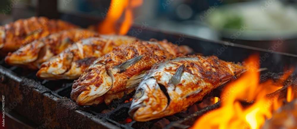 Smoky grill with assorted freshly caught fish on fire for outdoor seafood barbeque cooking Smoky grill with assorted freshly caught fish on fire for outdoor seafood barbeque cooking