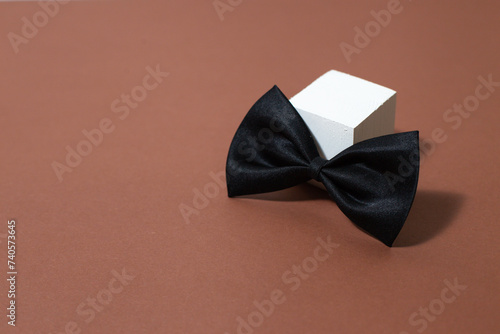 Black, stylish butterfly on a light background