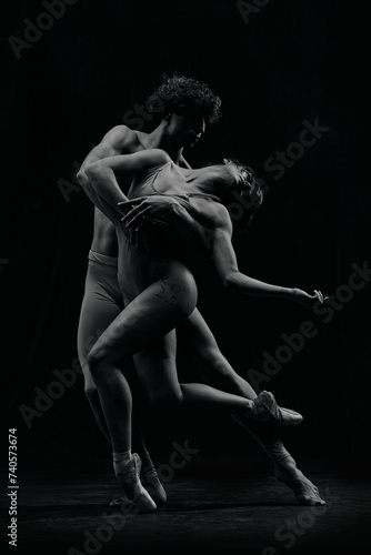 Beautiful young couple, man and woman, ballet dancers making creative performance. Black and white image. Concept of classic art, aesthetics, emotions, ballet dance, talent