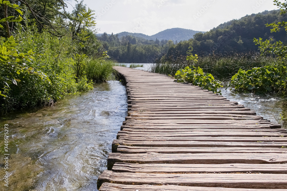 Fototapeta premium Path over a mountain lake. Plitvice lakes. Nature background. Selective focus