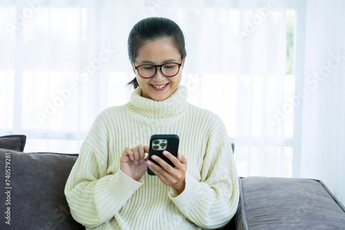 Woman spend time at home seated on sofa