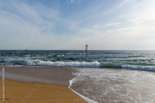 La barre d'Etel, submergée par les eaux à marée haute, se fond dans l'océan, tandis que le sable doré de la plage reste caché sous les vagues. 
