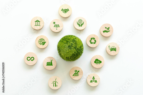 Green World is placed in the center, surrounded by wooden blocks with environment icons. Saving the environment, and being environmentally sustainable. Save Earth. Environment World Earth Day. ESG