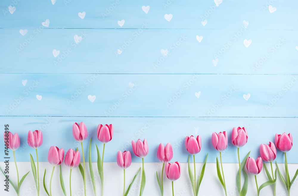 Pink tulips and white heart on a blue wooden background. Spring, natural concept. Pink tulips and white heart on a blue wooden background. Spring, natural concept.