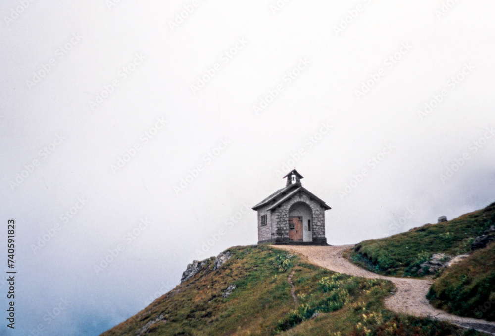 Small chappel in the Dolomites Italy in the fog. Nineties.