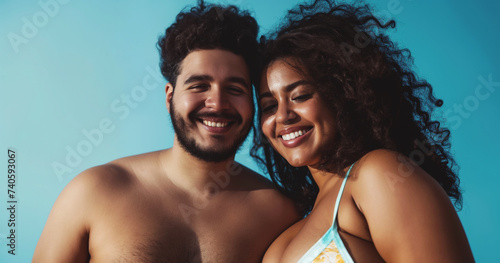 Young black couple in love on beach vacation, man and woman wearing swimsuits and smiling photo