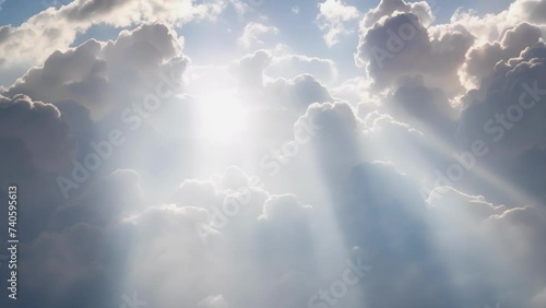 Sun rays cascade through a blanket of billowy cumulus clouds.