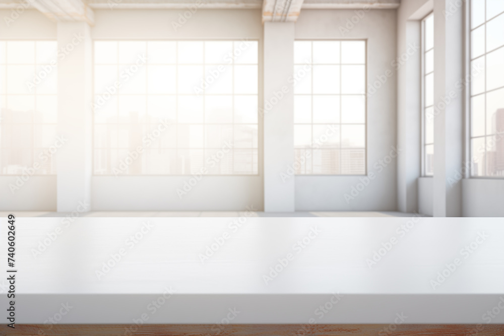 Fototapeta premium The empty white table on the background of a large office space with large windows overlooking the city. For product display montage.