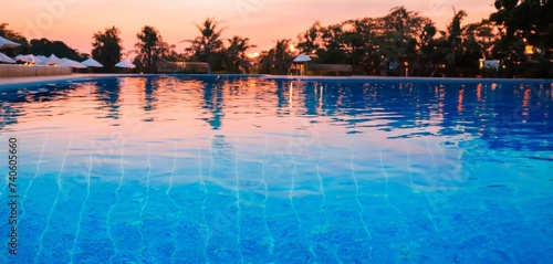 sunset in the swimming pool, closeup of a pool in a luxury hotel at sunset