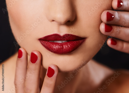 Beauty, cosmetics and mouth of woman with manicure, studio and lipstick with creative aesthetic. Luxury makeup, face and hands with red nail polish for self care, shine and model on black background