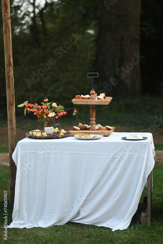 Obraz na plátně outdoors pristine Table With White Cloth with finger food for aperitive over in