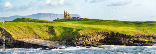 Famous Classiebawn Castle in picturesque landscape of Mullaghmore Head. Spectacular sunset view with waves rolling ashore. Signature point of Wild Atlantic Way, Co. Sligo, Ireland