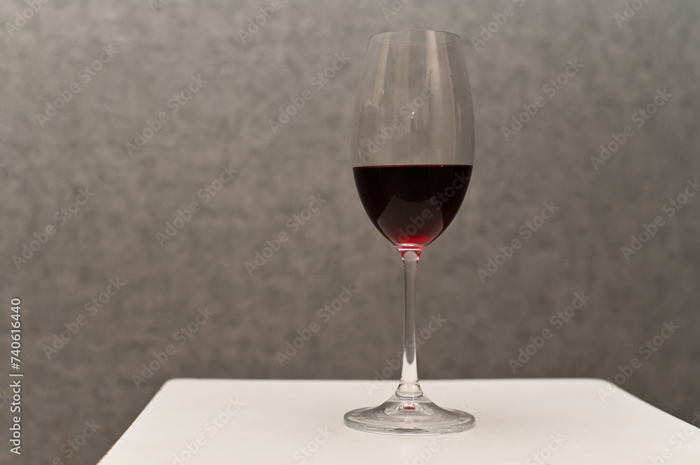 red wine in a glass. close-up on a gray background red wine in a glass. close-up on a gray background