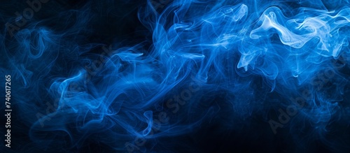 Ethereal blue smoke waves on elegant dark background for design inspiration and artistic concepts