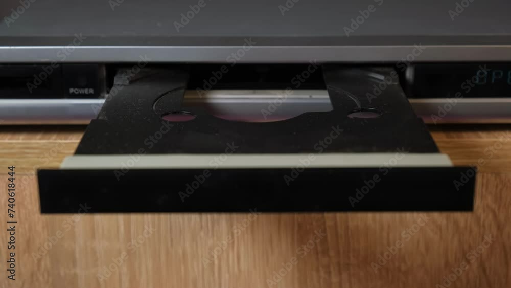 inserting a disc into the DVD player, starting the DVD player, turning on a movie on the DVD player, old technology inserting a disc into the DVD player, starting the DVD player, turning on a movie on the DVD player, old technology