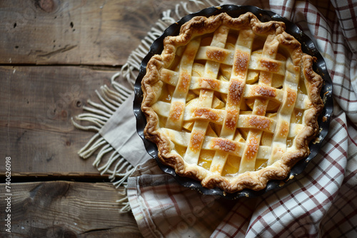 Homemade fresh apple pie on a light gray tablecloth on a wooden background. Copy space. Close up.