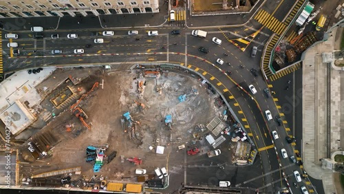 Drone Descends towards Construction Site as Cars Drive around Detour to Avoid Work photo