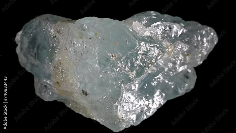 Aquamarine (blue form of Beryl) specimen rotating slowly against a black background. Aquamarine (blue form of Beryl) specimen rotating slowly against a black background.