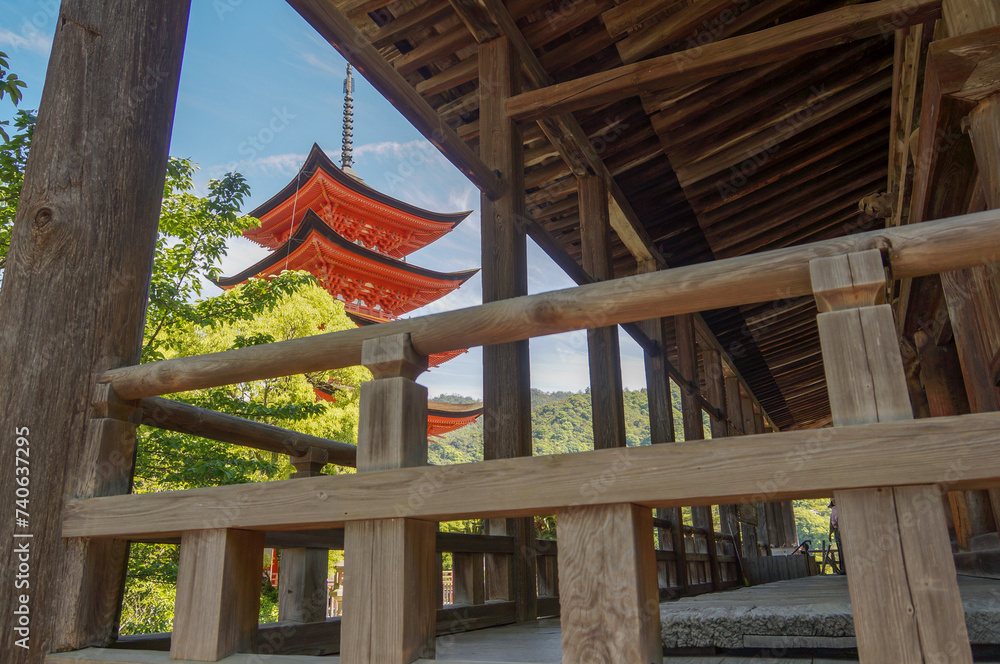 A five-story pagoda looking through from the wooden fences and columns of Senjokaku Pavilion (Hall of One Thousand Tatami Mats) on Miyajima Island in Hiroshima, Japan. A five-story pagoda looking through from the wooden fences and columns of Senjokaku Pavilion (Hall of One Thousand Tatami Mats) on Miyajima Island in Hiroshima, Japan.