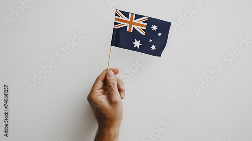 Hand holding flag of Australia cut out on white background, Patriotism National Symbol Identity Country Pride, Generative Ai   © Muskan
