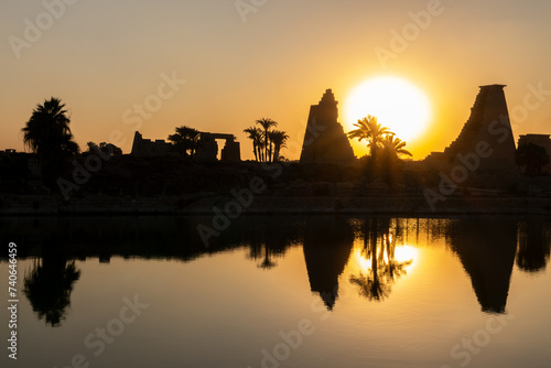 Karnak temple sacred lake at sunset on the East bank of the Nile river in Luxor, Egypt photo