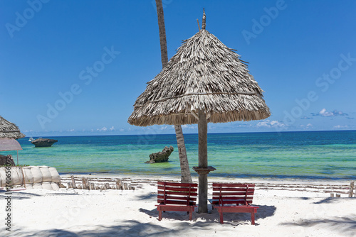 Chair and green trees on a white sand beach. Watamu, Kenya - Africa.