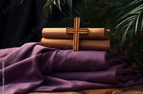 a wooden cross on a purple cloth against a palm tree