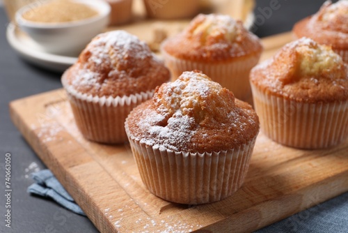 Delicious sweet muffins on black table, closeup