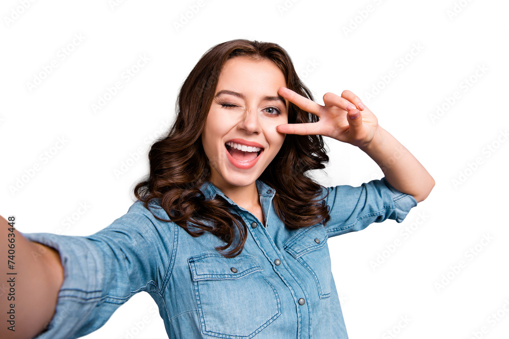 Self-portrait of nice cute cheerful lovely attractive magnificent brunette girl with wavy hair in casual denim shirt, opened mouth, showing v-sign near eye, isolated over grey background Self-portrait of nice cute cheerful lovely attractive magnificent brunette girl with wavy hair in casual denim shirt, opened mouth, showing v-sign near eye, isolated over grey background