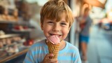 Closeup of a beautiful and cute little preschool boy holding an ice cream cone with white strawberry scoop, looking at the camera and smiling. Happy male kid or child eating dessert in the summer