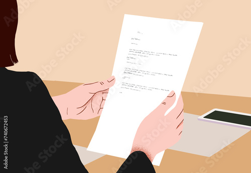 Businesswoman reading a document at her desk photo