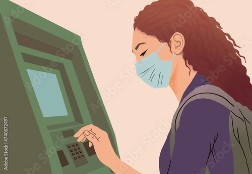 Woman using ATM with safety mask during pandemic photo