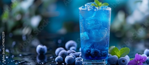 Refreshing blueberry cocktail with ice cubes and freshly picked blueberries for a fruity summer drink