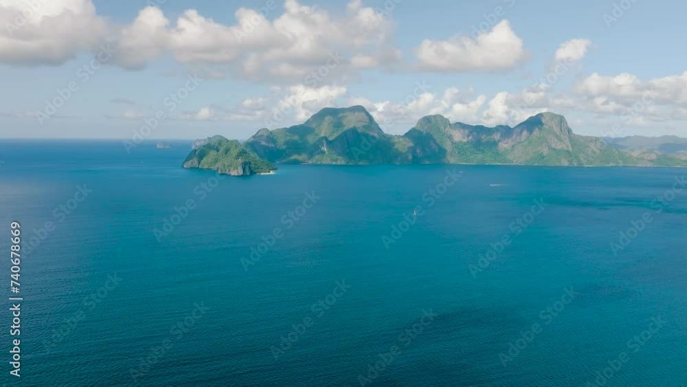 Drone view of Helicopter Island and Cadlao Island surrounded by blue sea. El Nido. Palawan, Philippines.