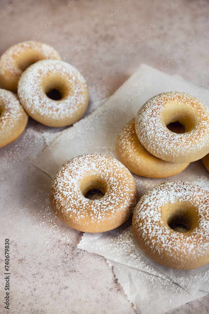 Group of baked donuts covered with powdered sugar high angle view vertical image