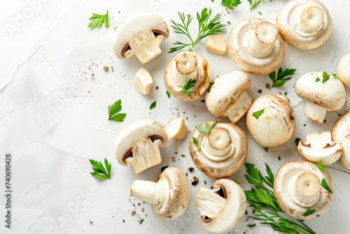 Set of fresh whole and sliced champignon mushrooms on white background. Top view. photo