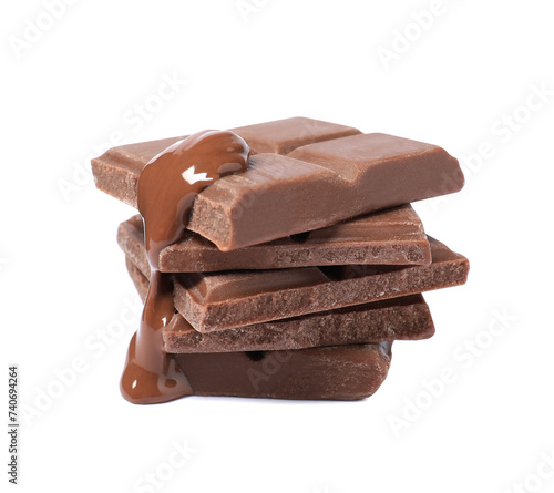 Pieces of milk chocolate with tasty paste isolated on white